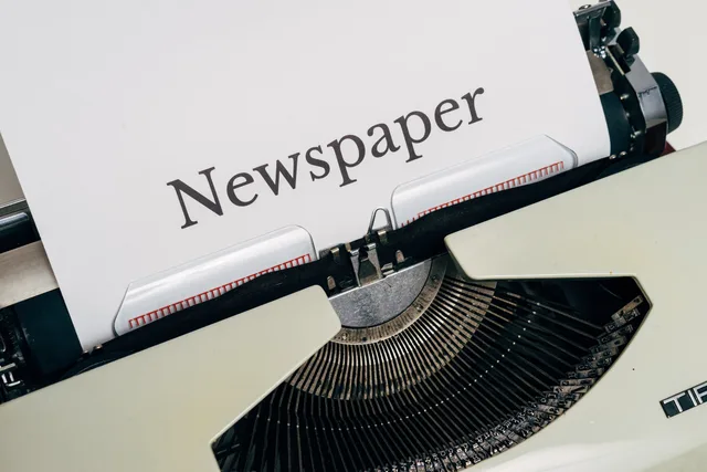 Close-up of a vintage typewriter printing the word 'Newspaper' on paper. Newsletter service standards defined by lane, event and clock instead of invented SLAs